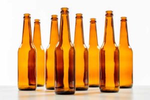 Several empty beer bottles no a white background