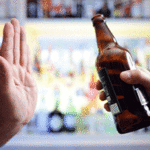Person refusing a beer with a hand signal