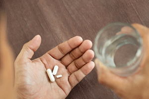 Pills and alcohol in a person's hands