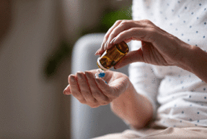 MAT patient pouring pills into their palm