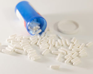 Pills sprawled across a white table