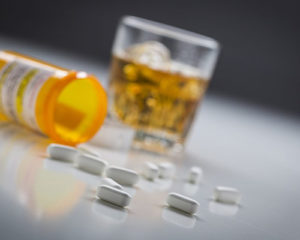 Addictive pills spilling across a table
