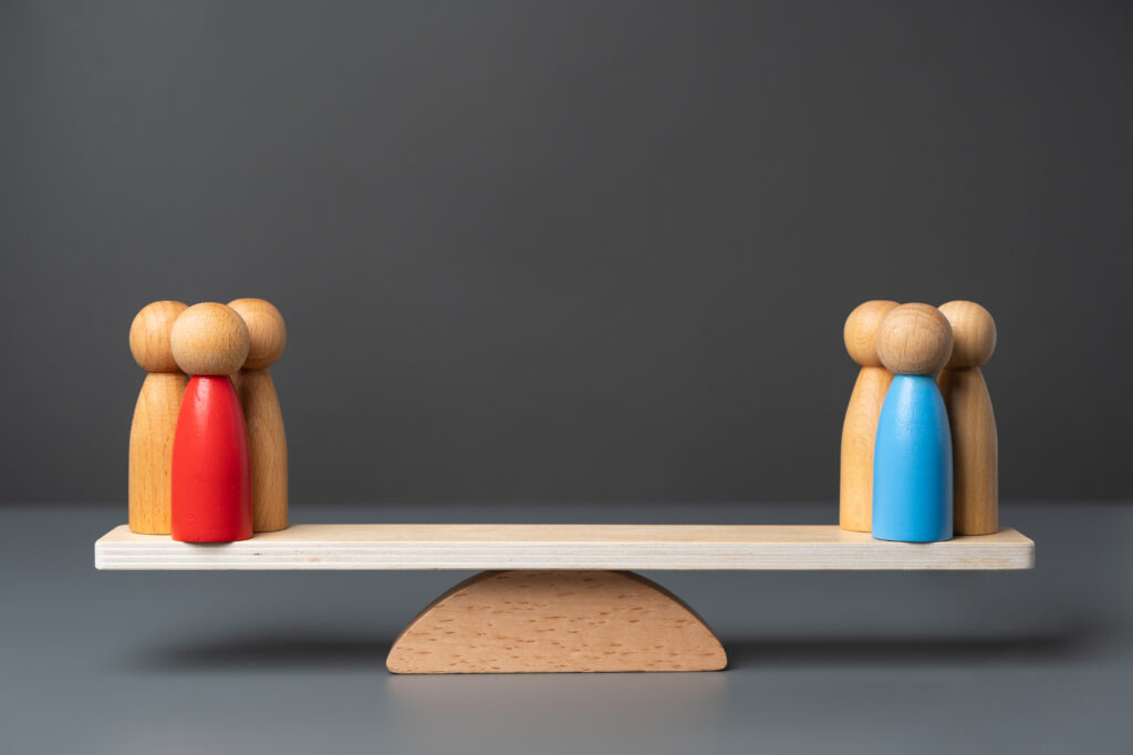 Two opposing teams on the scales. Rivalry between groups and leaders. The state and parties. Two major political parties. Democratic elections.