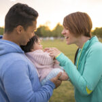 Couple playing with baby in park