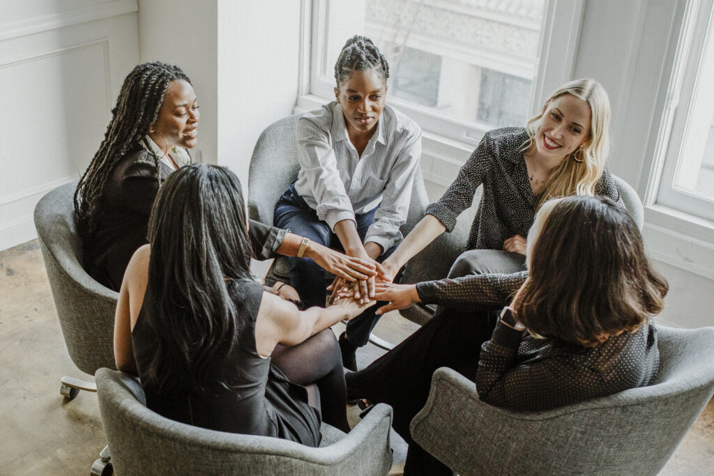 Business people stacking hands in the middle