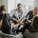 Business people stacking hands in the middle