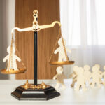 On the judge's scales, there are figures of people in each bowl, with a waiting line or other figures of people watching below. Social justice, comparison, inequality, court, public condemnation, dispute resolution