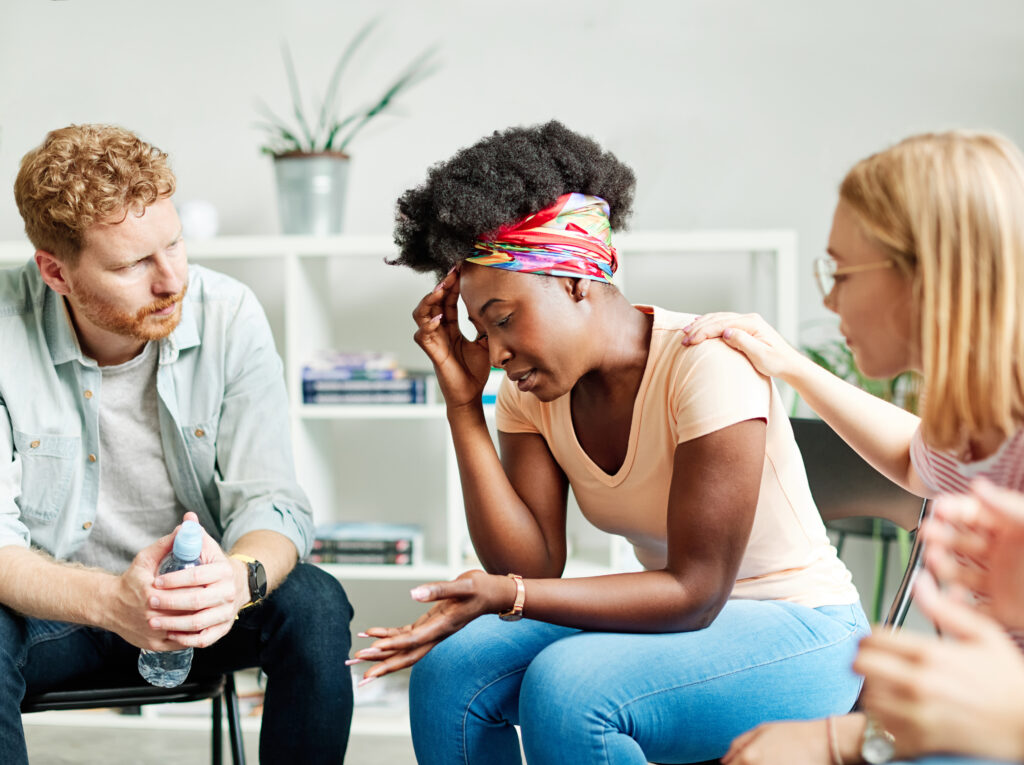 Group psychotherapy. Persons sitting in circle and talking. People meeting. Psychotherapy training, business lecture or conference. Man woman support group