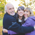 Happy family smiling hugging outdoors